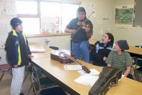 Robert Castel performing for some of his grade 8 Cree class