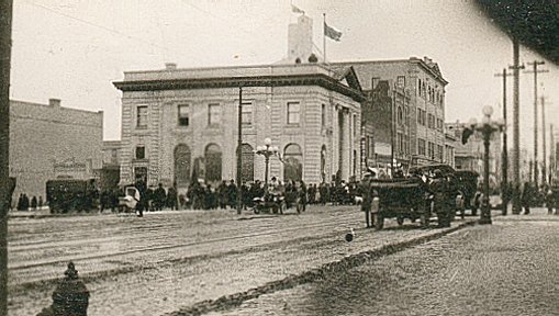 Looking east on Rosser Ave. at 11th St.: Merchants Bank Bldg (became library and Chamber of Commerce)