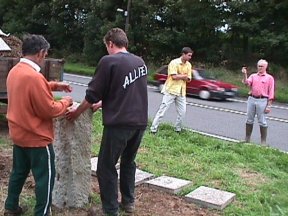 [9] Don and James Mitchell brave the A51 traffic to direct the leveling of the stone.