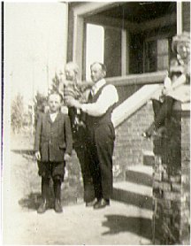 Jack Campbell Holding Billie at Front Entrance to Home