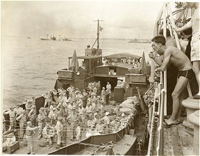 US landing craft with ex-POWs (Quebec Rifles and Jesuit Missionaries)