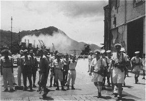 PR439: Lt. Whithall leading platoon by rounded-up Japanese