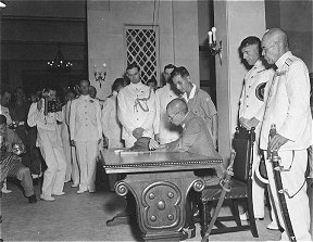 PR551: Japanese officer signing surrender papers